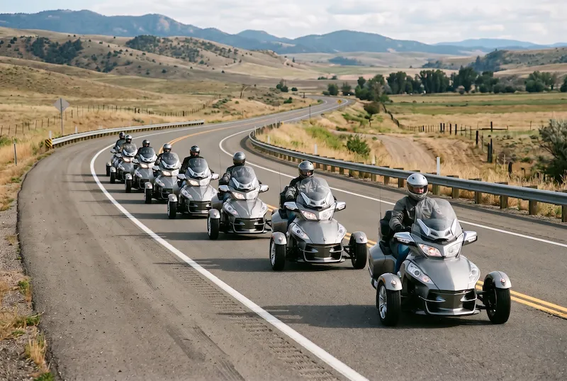 A line of identical plain touring three-wheelers riding down a highway, each one hard to tell apart