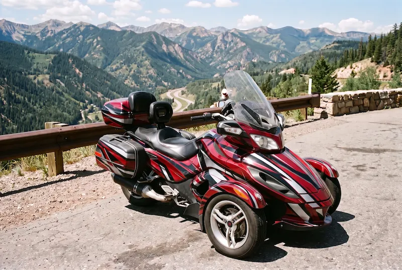 After: the same three-wheeler with a bold red, black and silver graphic kit on its nose, fenders, trunk and bags